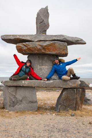 adventurers posing on rock formation